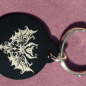Black and Gold Keychain with Intricate Design